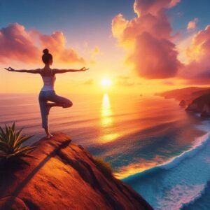 Woman in tree pose on a cliff at sunset with ocean waves below.