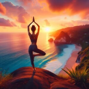 Woman in warrior yoga pose on cliff overlooking sunset ocean view.